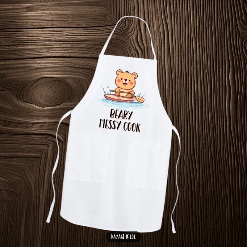 Funny bear kayaking and splashing water with a paddle, on an apron, ideal for a fun and protected cooking experience.