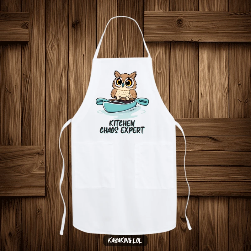 Funny owl apron showing a startled bird in a kayak, its wide eyes and near-capsize illustrating a humorous kitchen mishap for cooks.
