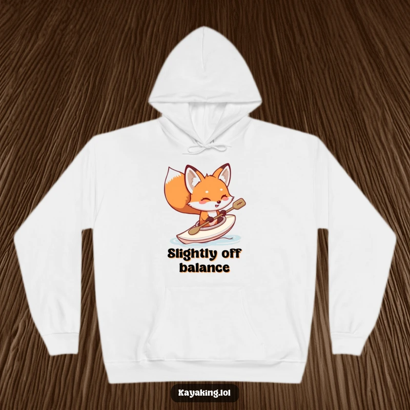 Funny fox kayaking hoodie, a red fox humorously tipping its kayak, water splashing around, perfect cozy wear for adventurers.