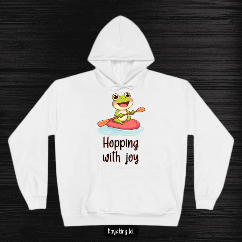 Funny frog with determined expression paddling a kayak, printed on a cozy hoodie for ultimate comfort.