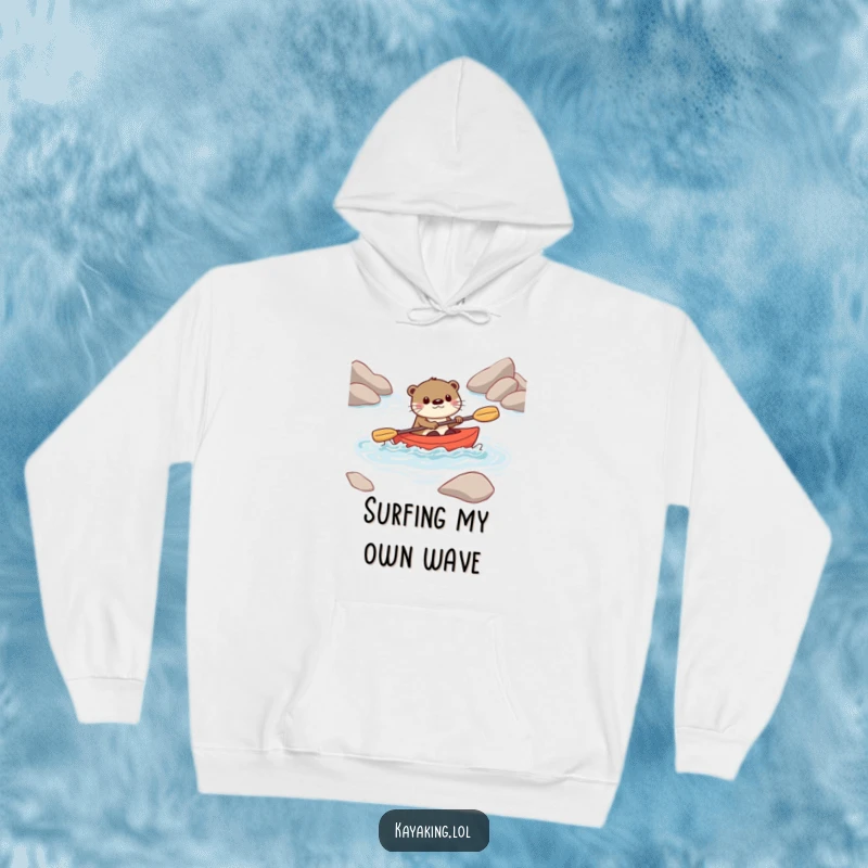 Funny hoodie featuring a playful otter character navigating rough water in a small kayak, showing skill and enjoyment.