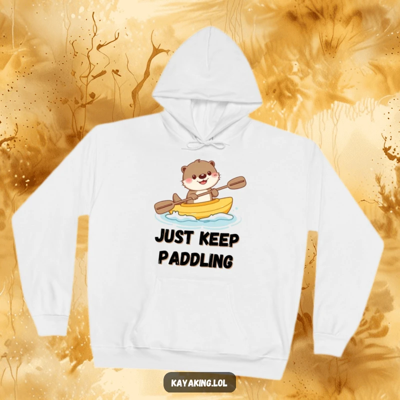 Funny hoodie depicting a happy otter enthusiastically paddling a tiny kayak, surrounded by cheerful water splashes and good vibes.
