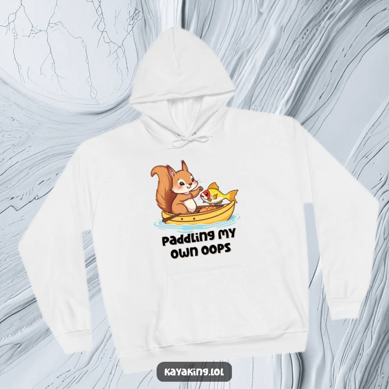 Funny Hoodie, a comical squirrel attempting to fish from a kayak, highlighting a humorous outdoor adventure and a cozy feel.