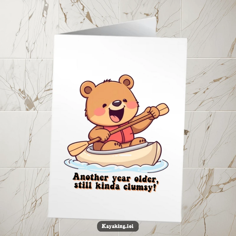 Funny Free Printable Birthday Card: An excited bear clumsily tries to steer a kayak with a paddle, full of birthday spirit.