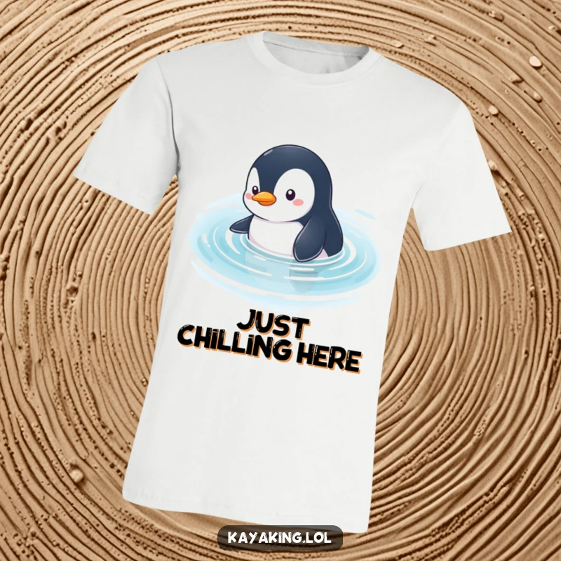 Funny Penguin T-Shirt: A curious penguin glides through calm water, looking around with an inquisitive expression.