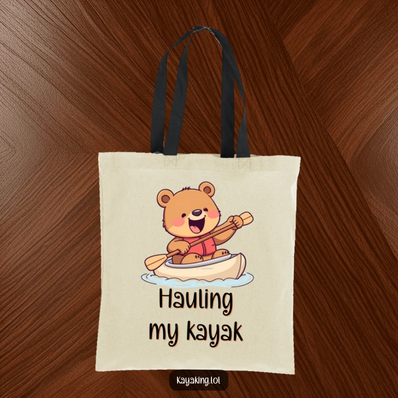 Funny tote bag with an excited bear attempting to steer a kayak with a paddle, a humorous and practical accessory for any adventure.